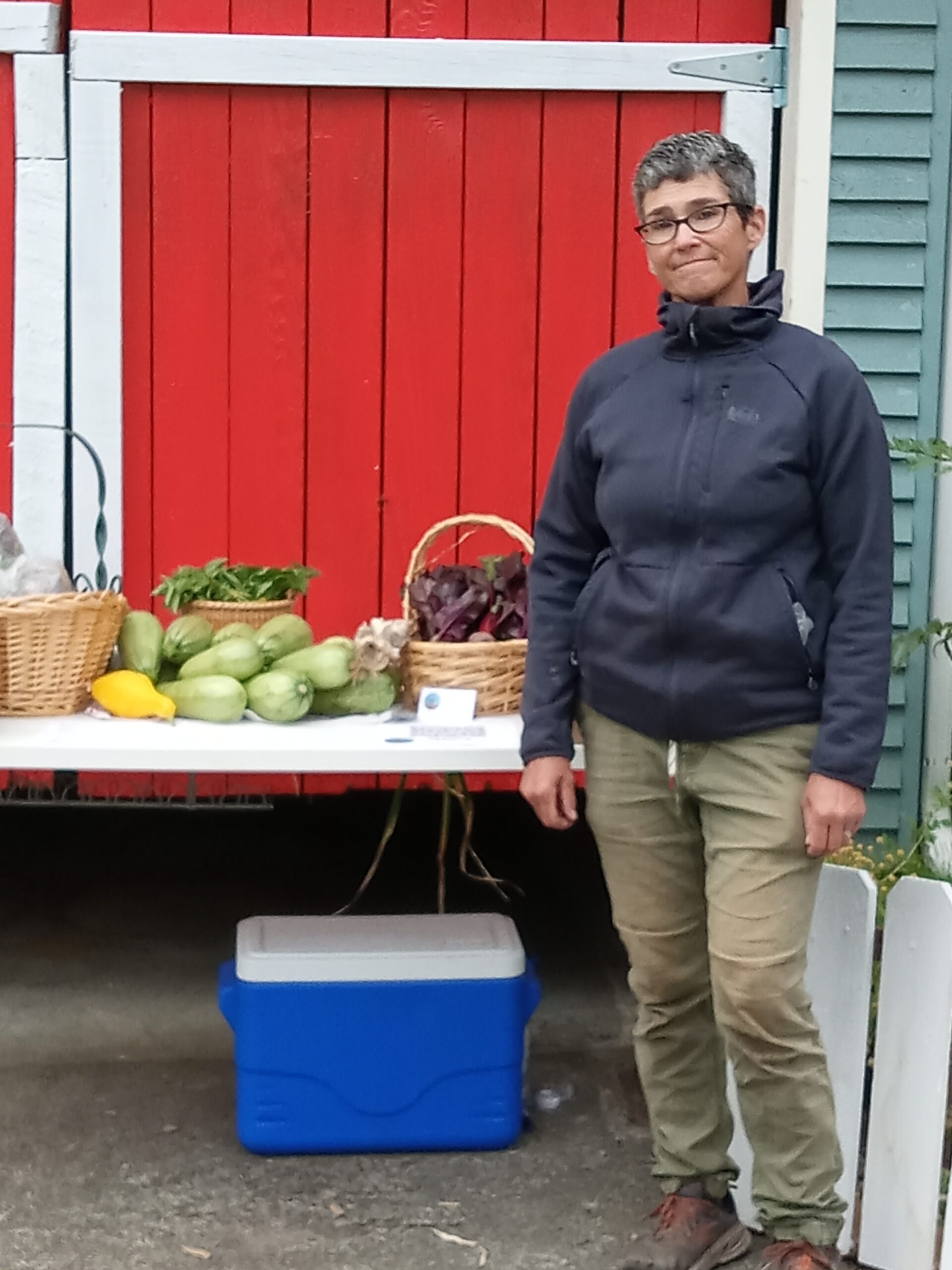 person standing in front of produce table